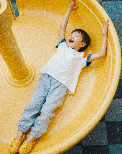 Child on a yellow slide