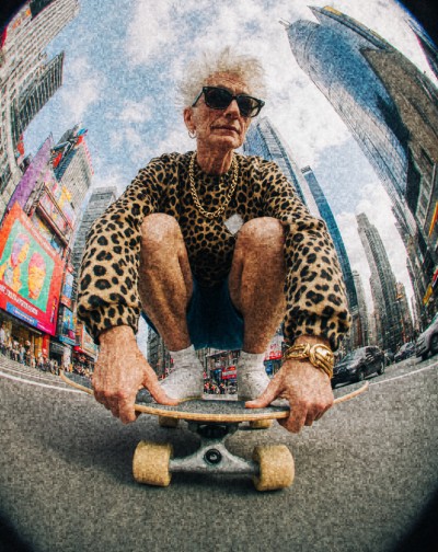 Older woman with sunglasses on a skateboard
