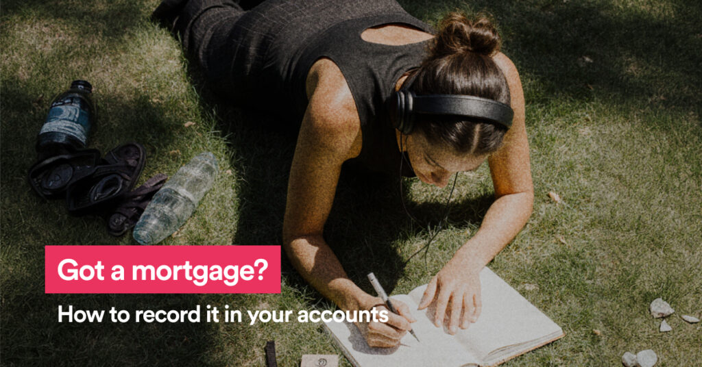 Woman sitting on the grass writing and the text Got a mortgage?